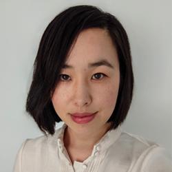 A woman with short black hair in a white shirt