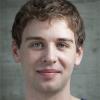 A man with curly light brown hair